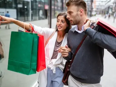 pareja comprando en tiendas de Barcelona con bolsas de colores